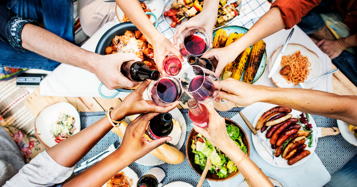 Group of friends toasting in one of the many restaurants in Ibiza during their holidays